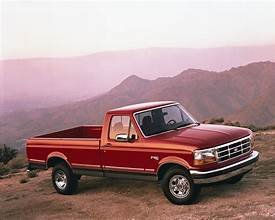 Red OBS Ford truck in the mountains